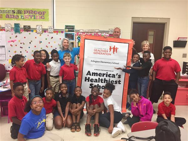  Arlington students and staff pose with their reward as one of America's Healthiest Schools